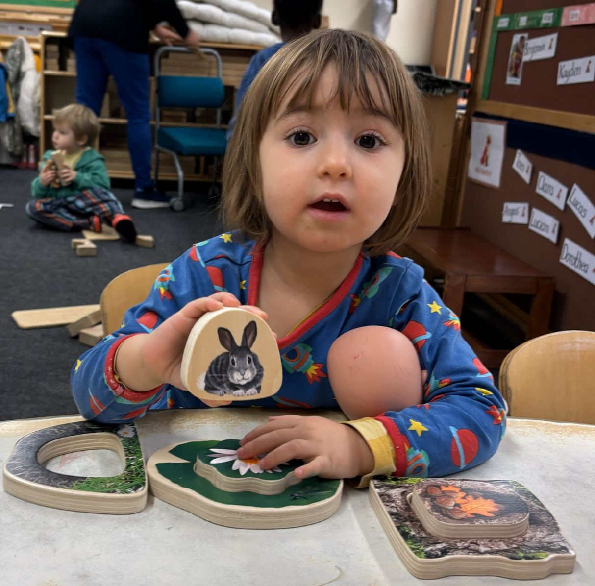 Child playing with the Yellow Door Who’s Hiding? Woodland Animals