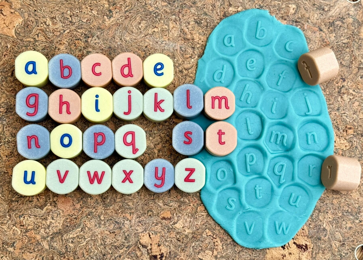 Close-up of engraved alphabet stamping stones showing letter details
