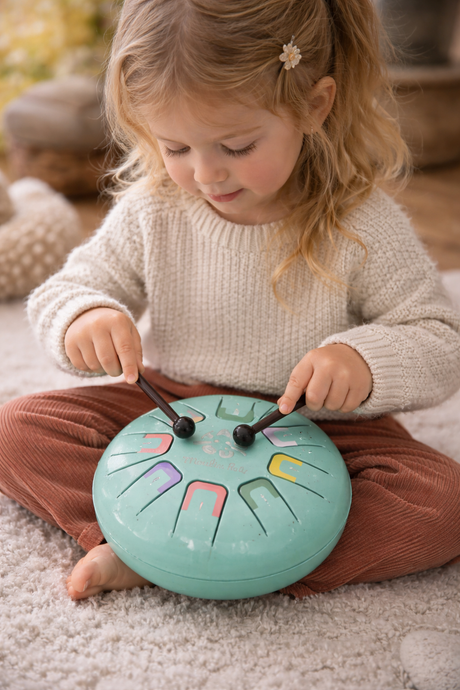 child playing the tongue drum