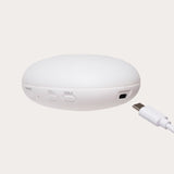 White electronic device with USB cable on a light gray background